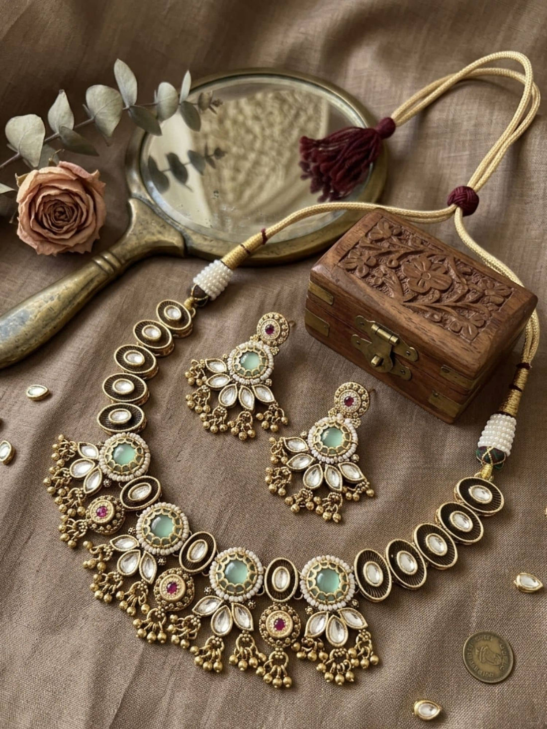Beautiful necklace for gold featuring intricate detailing, paired with matching earrings and traditional attire