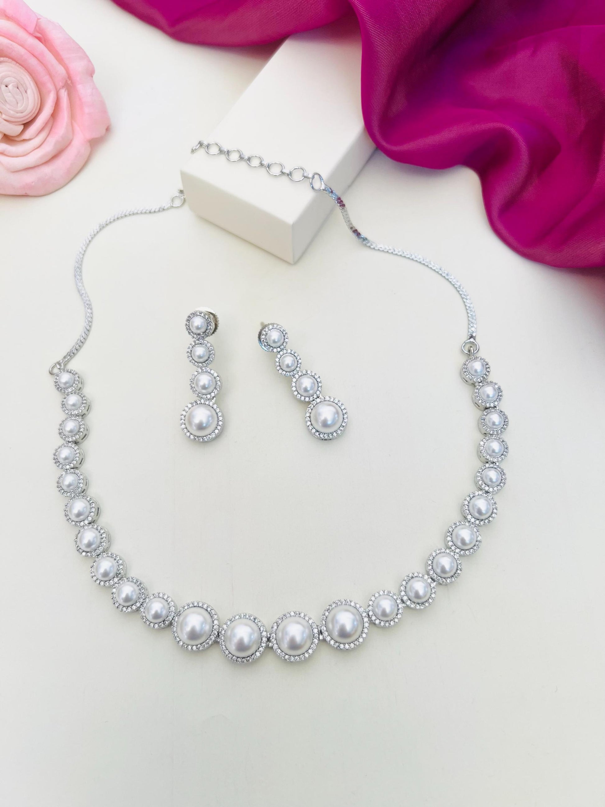 Pearl American Diamond Necklace Set with Matching Earrings by Abdesignsjewellery displayed on white surface
