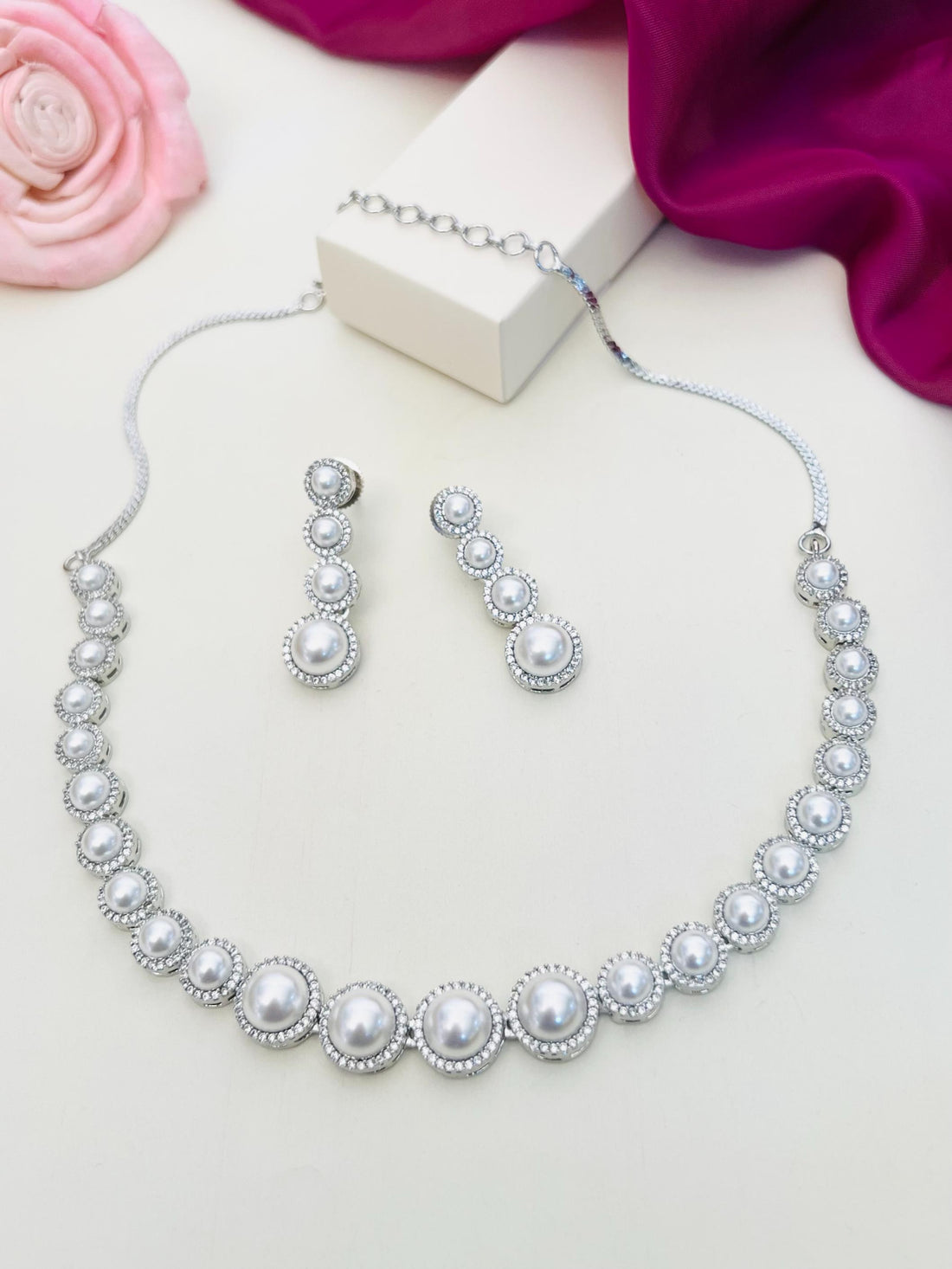 Pearl American Diamond Necklace Set with Matching Earrings by Abdesignsjewellery displayed on white surface