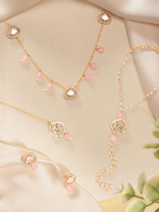 Gold Polki Hand Bracelet Combo with pink stone accents from Abdesignsjewellery on beige fabric