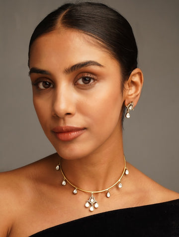 Polki Stone Gold Plated Hasli Necklace Set by Abdesignsjewellery worn by woman with matching earrings