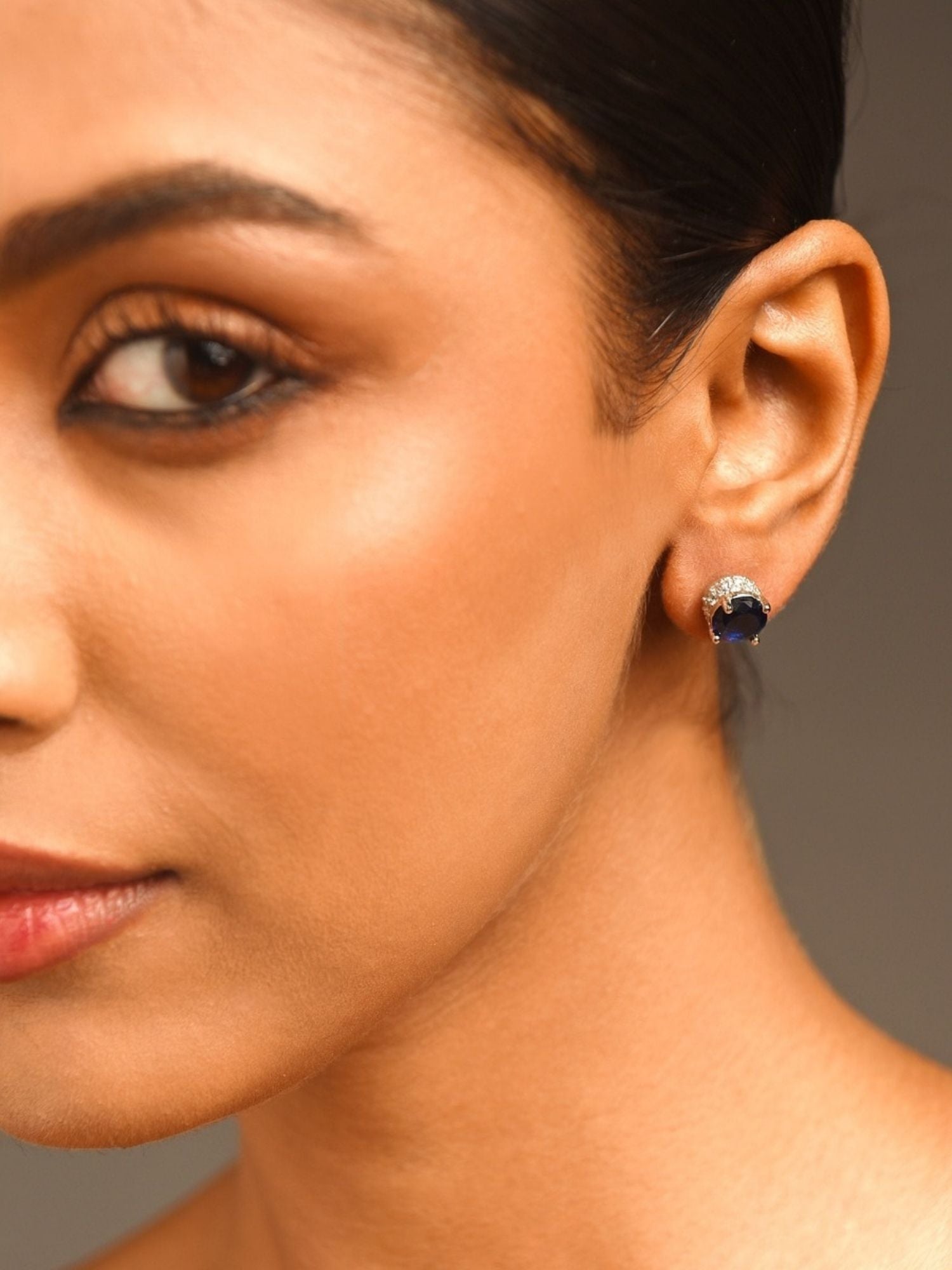 Precious Silver Plated American Diamond Stud Earring worn on ear by woman showcasing elegant jewelry