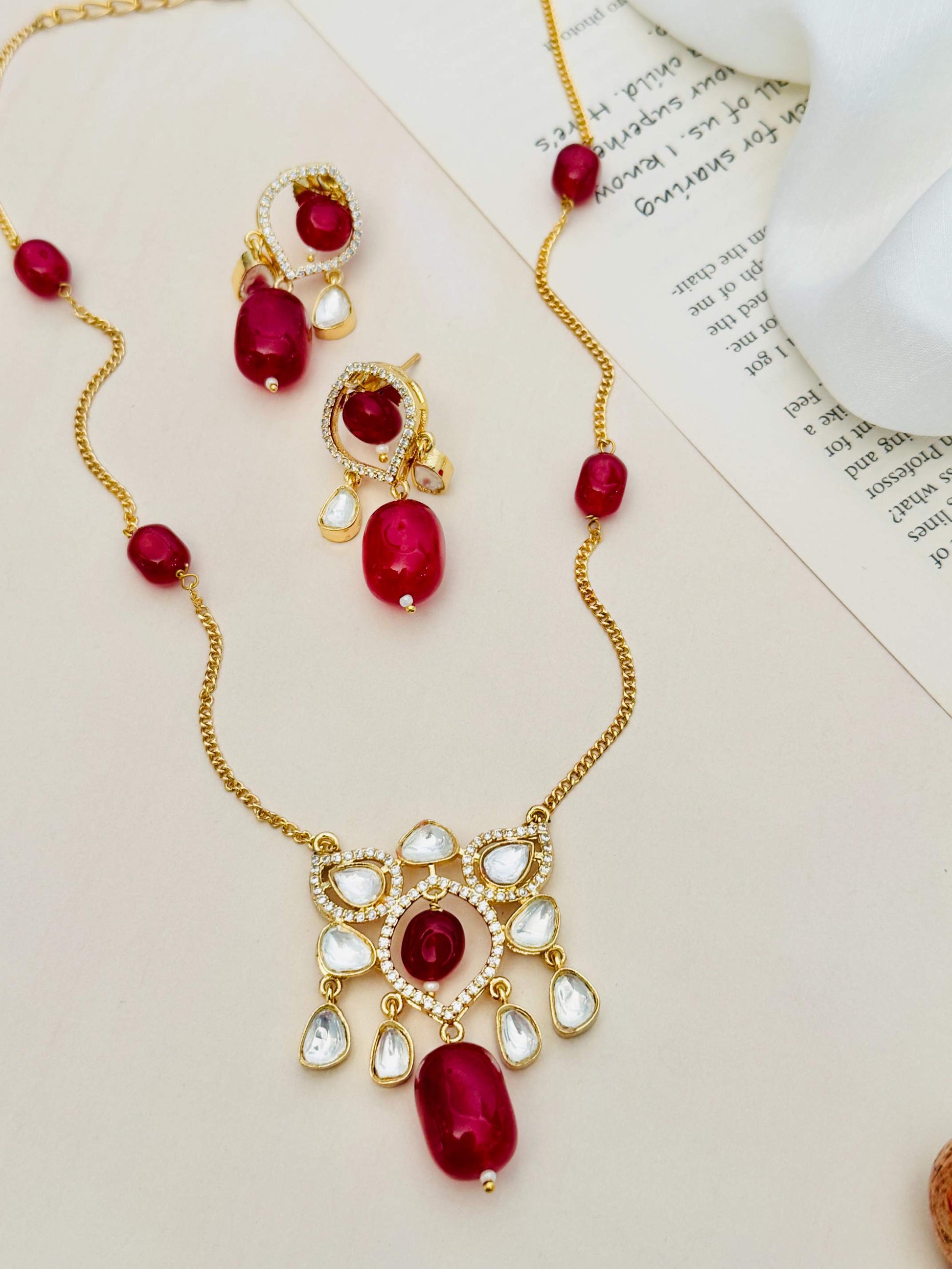Abdesignsjewellery Premium Gold Plated Polki Pendant Set with red stones and white crystal accents on a gold chain