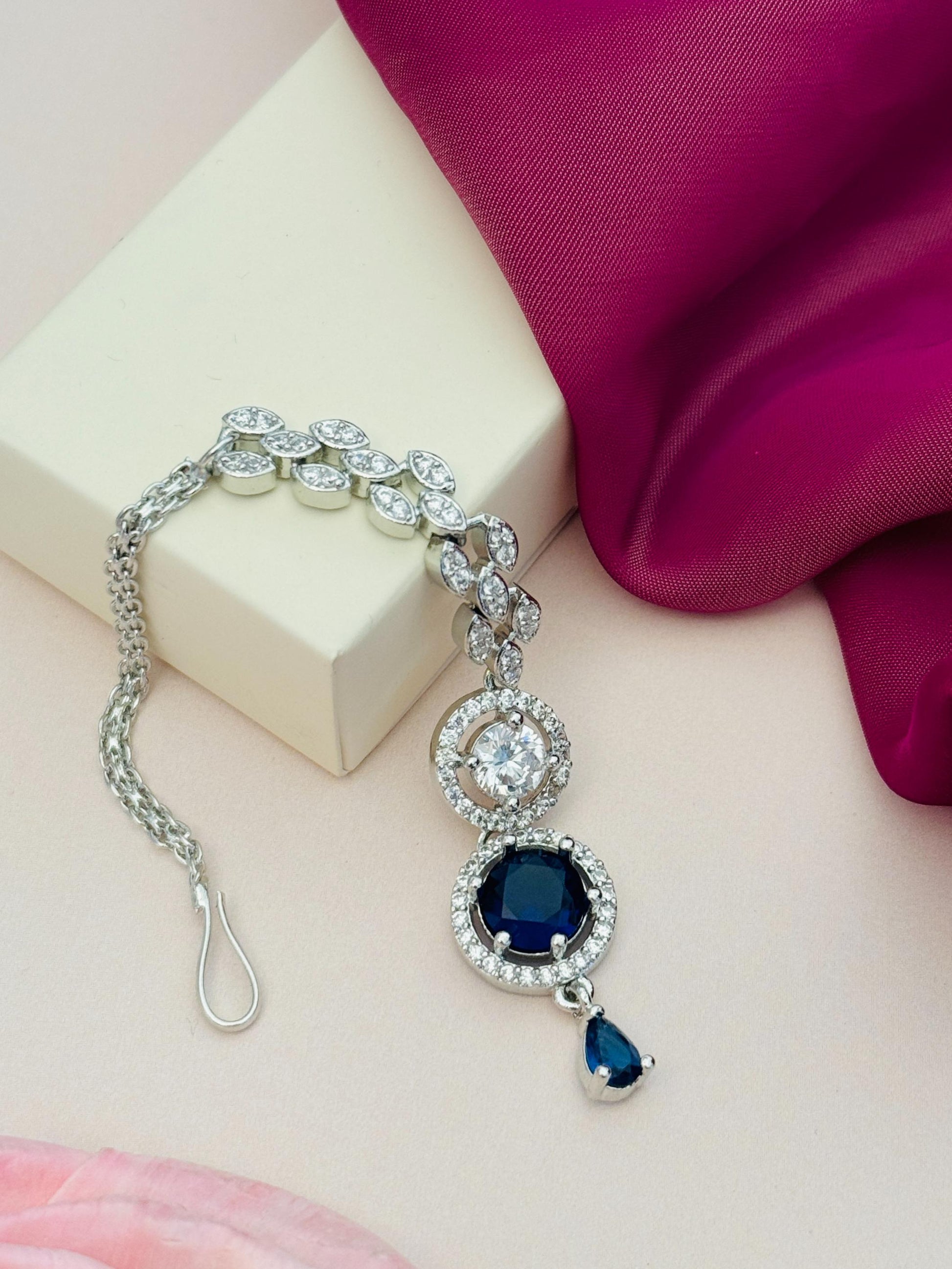 Round Silver Plated American Diamond Maangtikka with blue stones and intricate design by Abdesignsjewellery