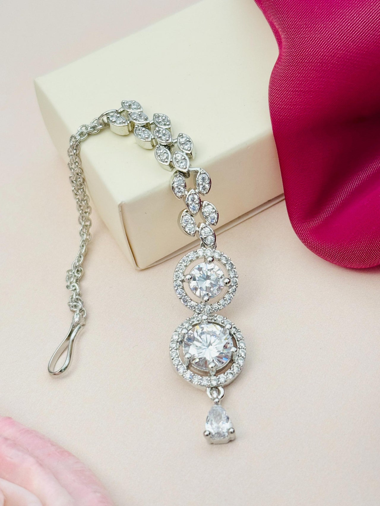 Round Silver Plated American Diamond Maangtikka with intricate floral design and teardrop pendant by Abdesignsjewellery