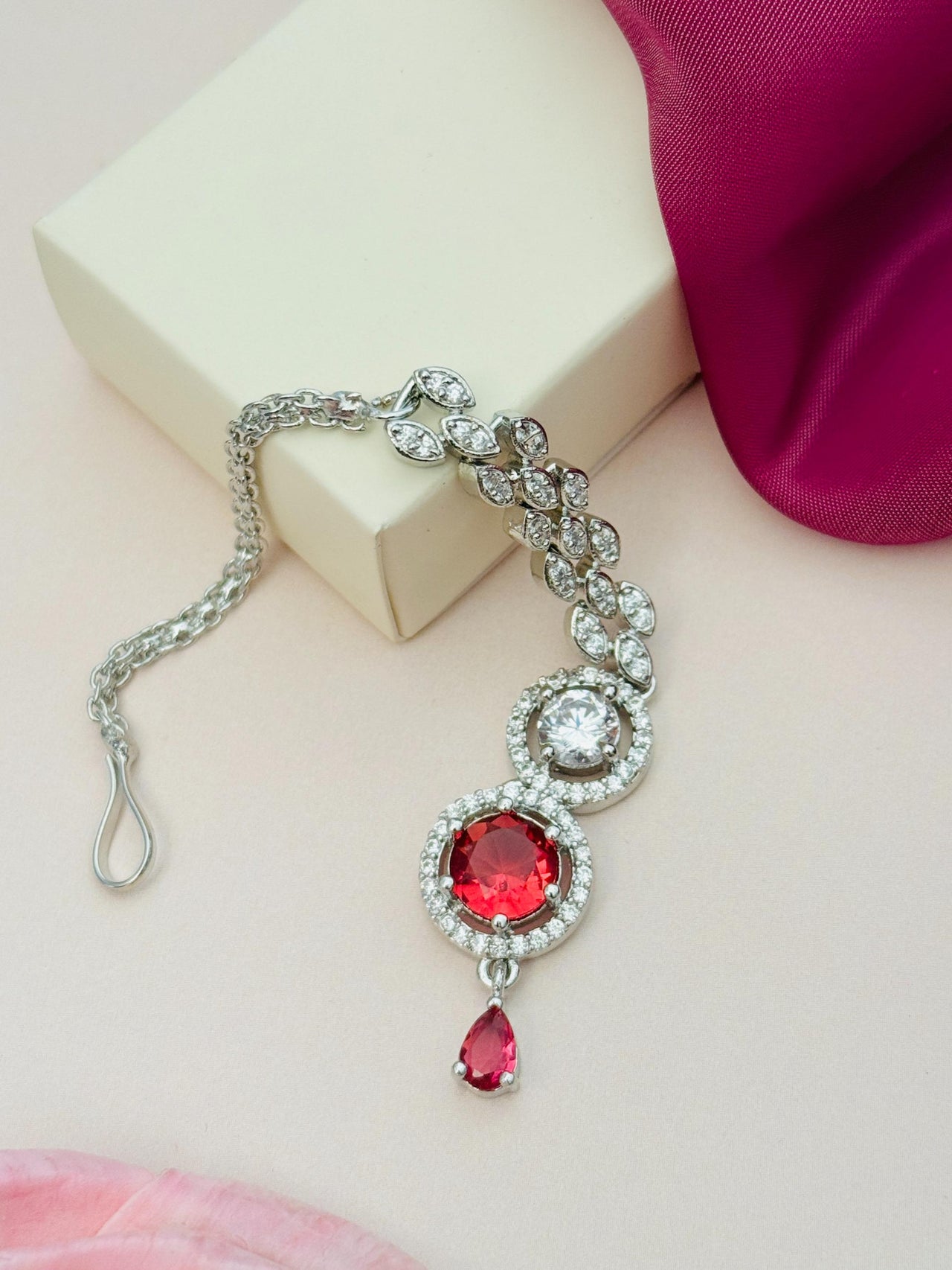 Round Silver Plated American Diamond Maangtikka featuring red and clear stones with intricate design by Abdesignsjewellery