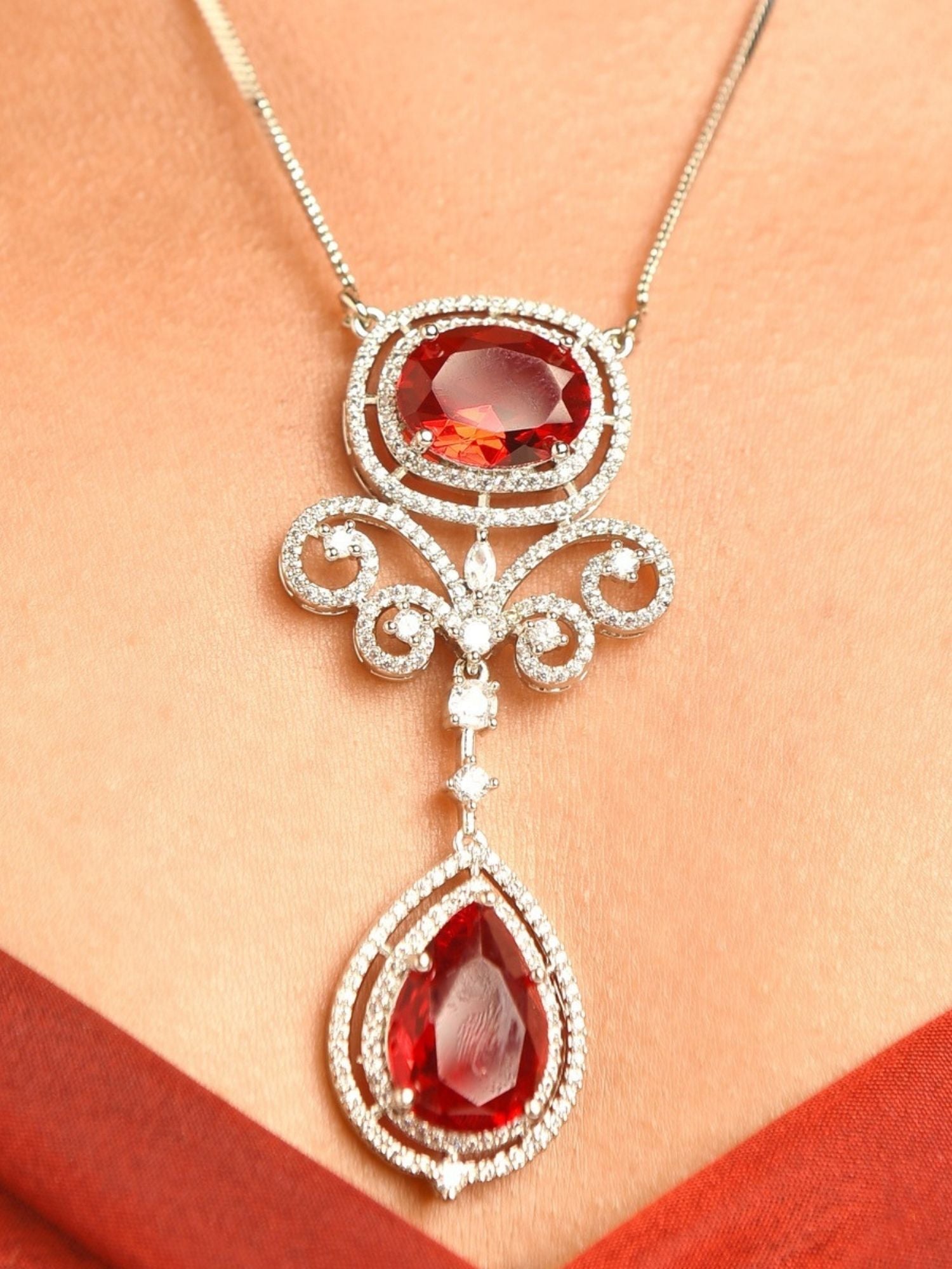Abdesignsjewellery silver plated ruby pendant set featuring ornate silver filigree with oval and teardrop rubies on chain