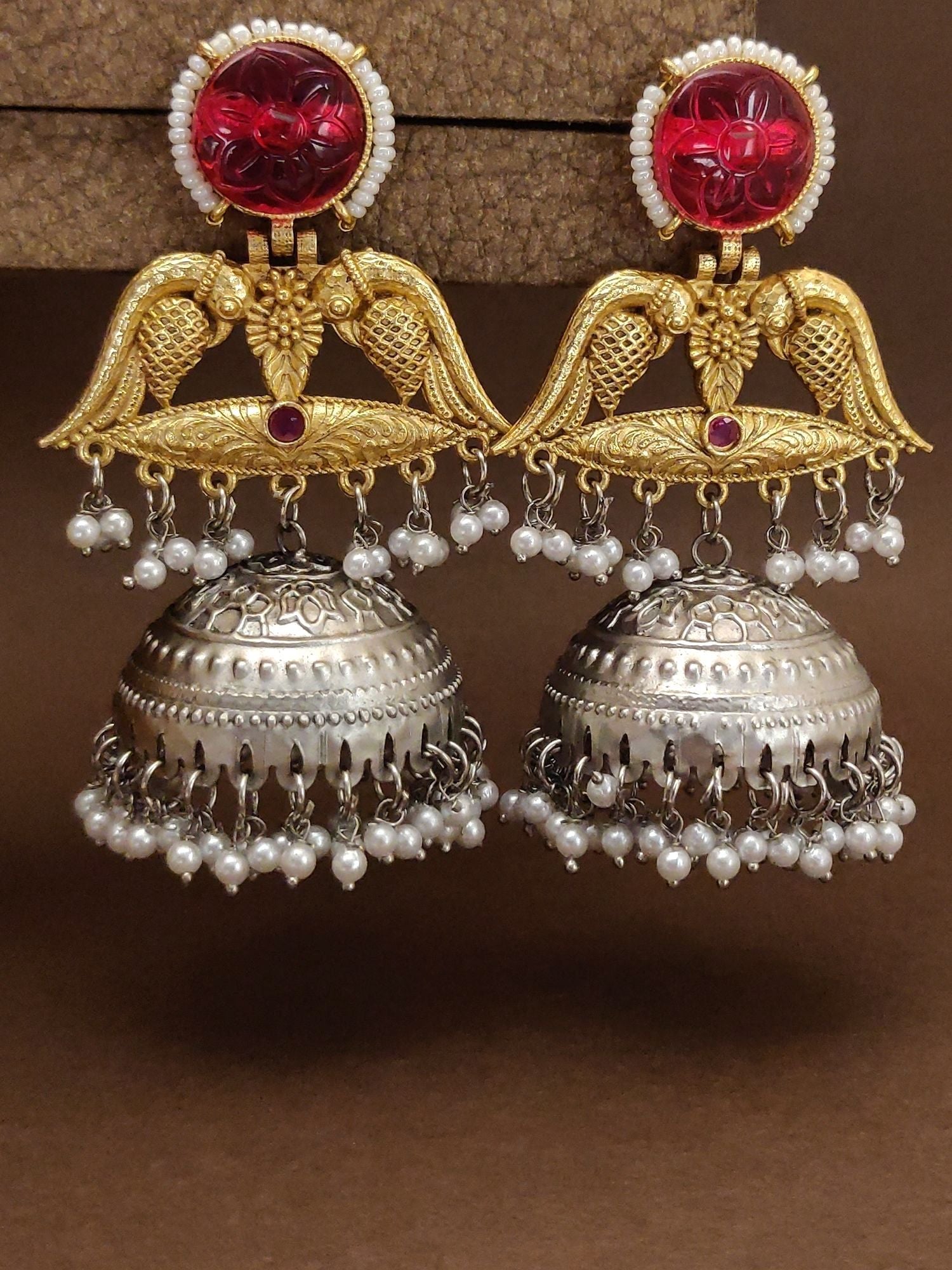 Stunning ruby peacock jhumka earrings with intricate gold detailing and pearl accents