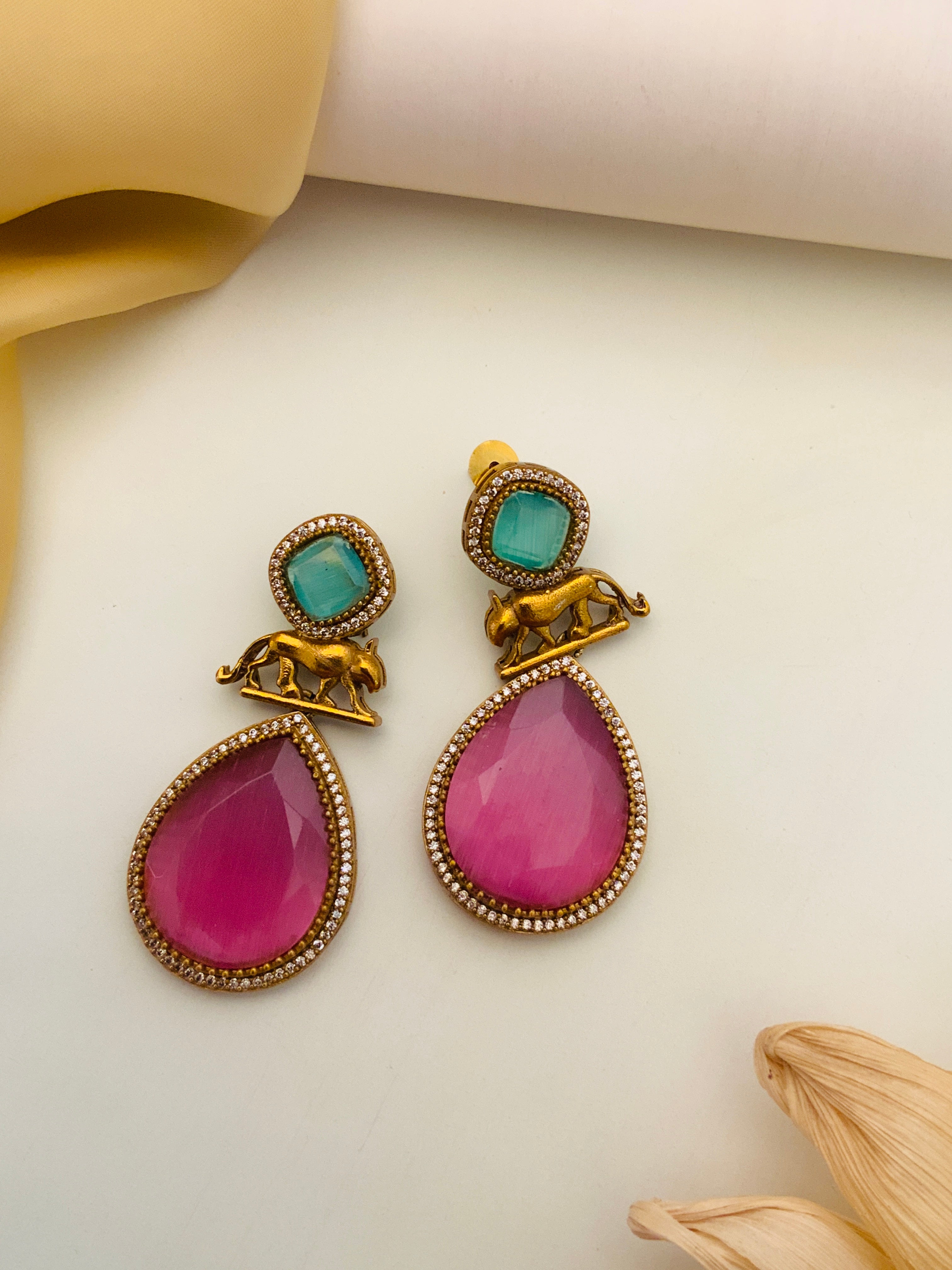Abdesignsjewellery Sabyasachi Earrings with pink teardrop stones and green square gems accented by gold elephant design