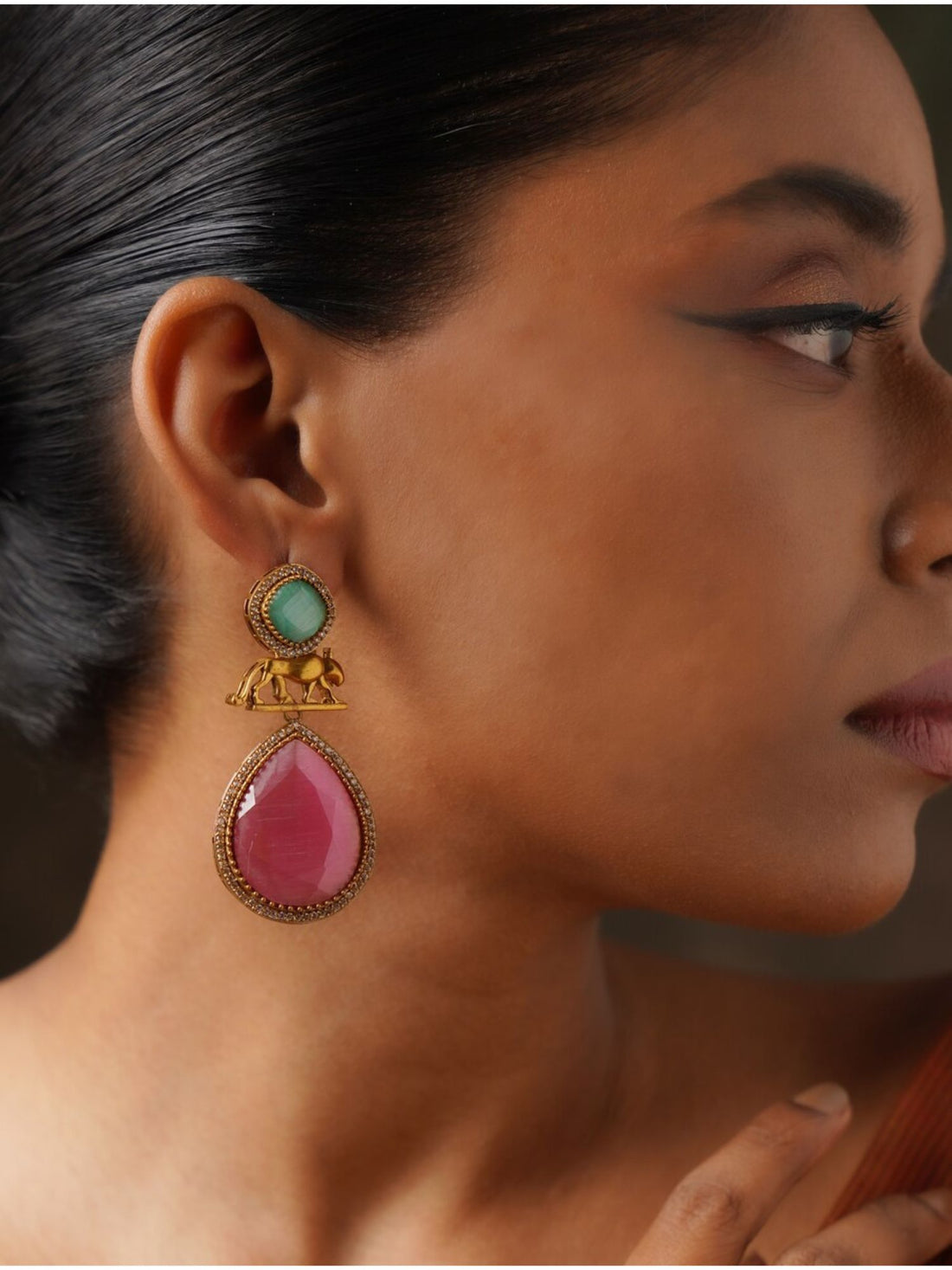 Abdesignsjewellery Sabyasachi Earrings with green stone, elephant motif, and pink teardrop pendant on model