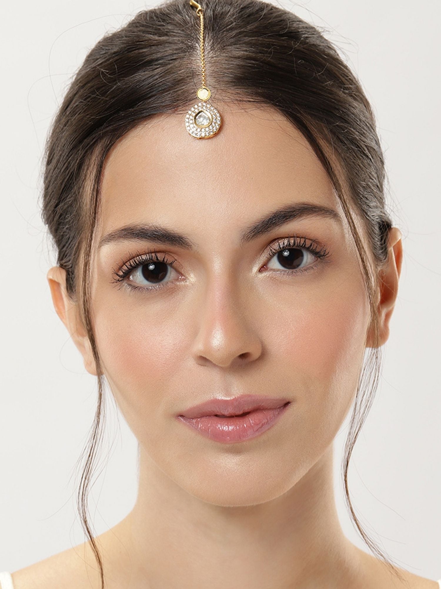 Elegant model showcasing a Set Of 2 Gold Plated Polki Maangtikka Combo, perfect for festive occasions.