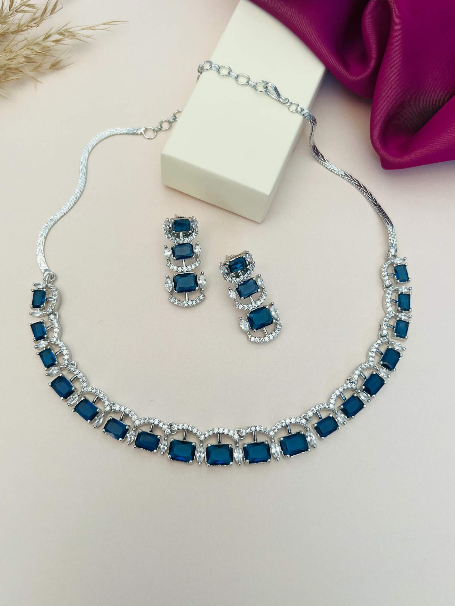 Silver American Diamond Necklace Set by Abdesignsjewellery with blue stones and matching earrings