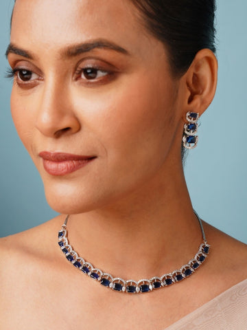 Silver American Diamond Necklace Set with blue stones worn by woman in elegant style