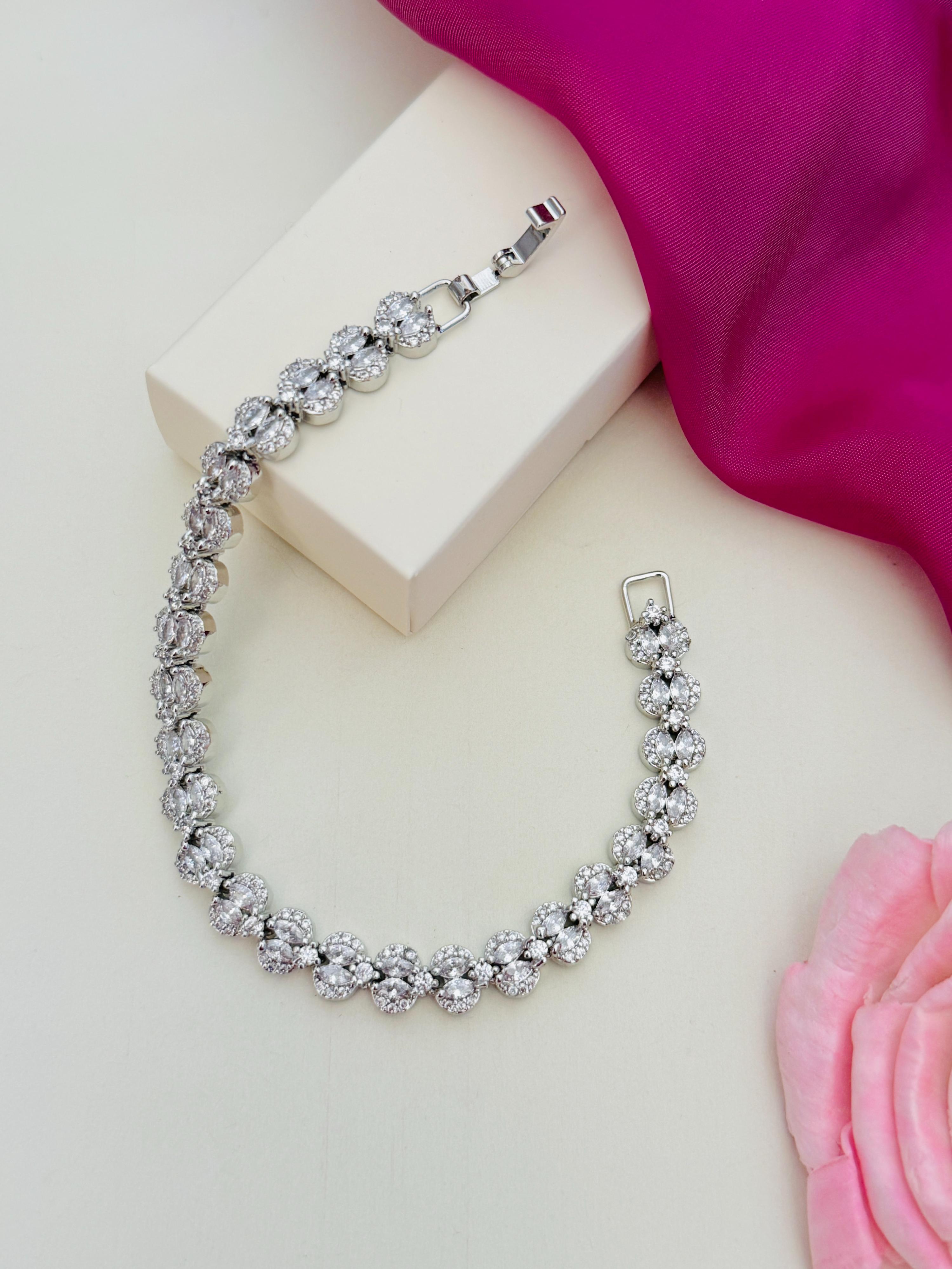 Silver Plated American Diamond Bracelet from Abdesignsjewellery displayed on white surface with pink fabric and flower