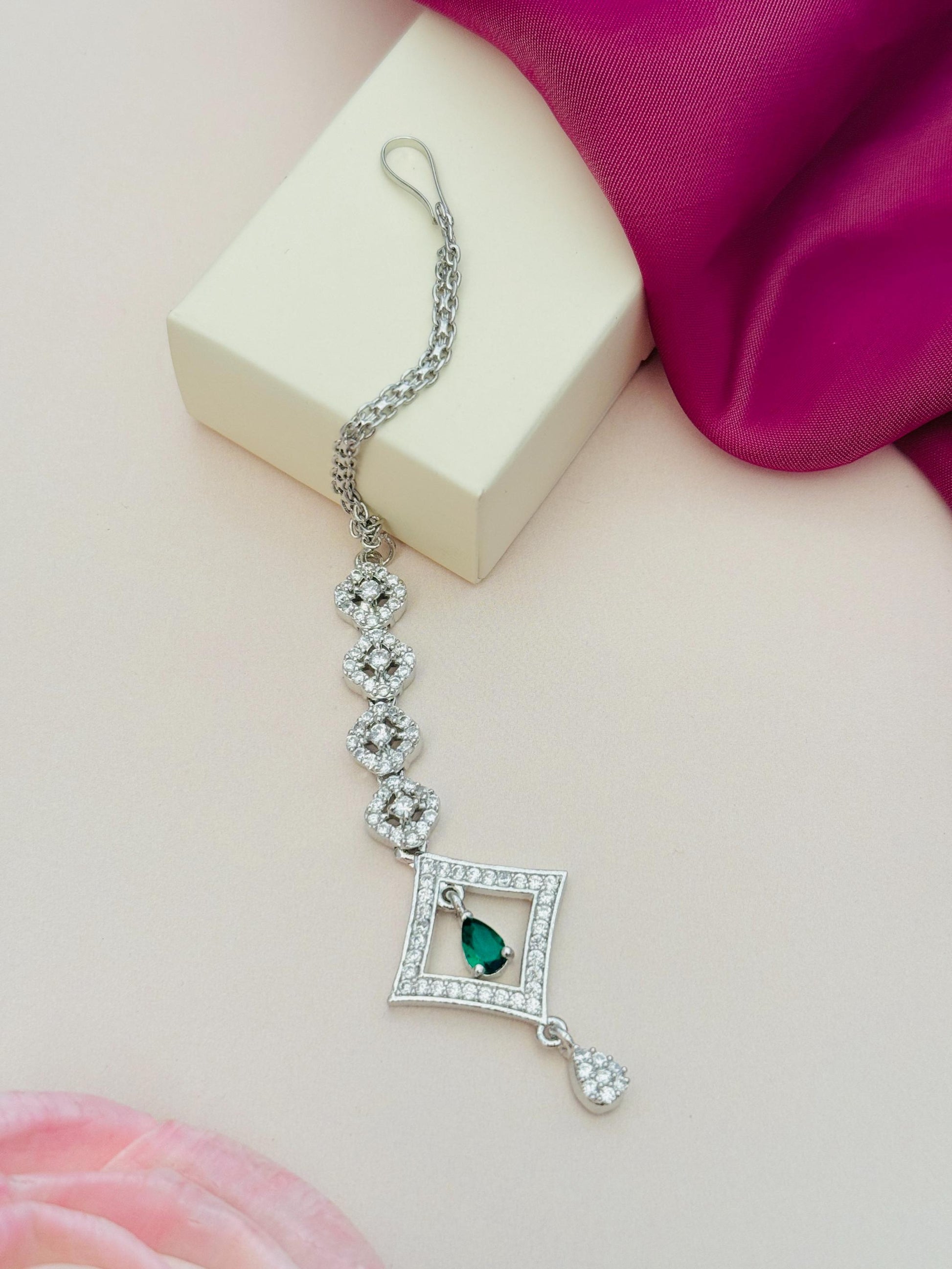 Silver Plated American Diamond Maangtikka with green stone and intricate floral design by Abdesignsjewellery