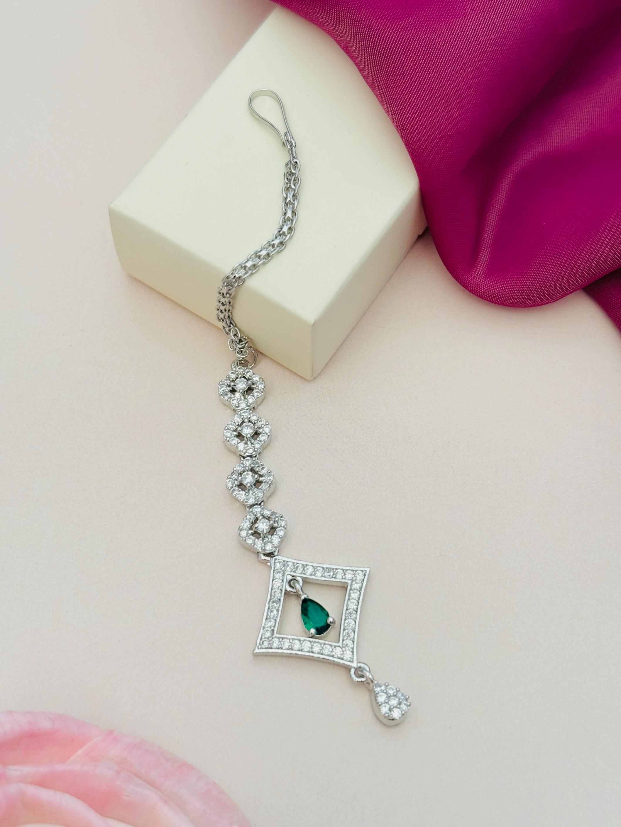 Silver Plated American Diamond Maangtikka with green stone and intricate floral design by Abdesignsjewellery