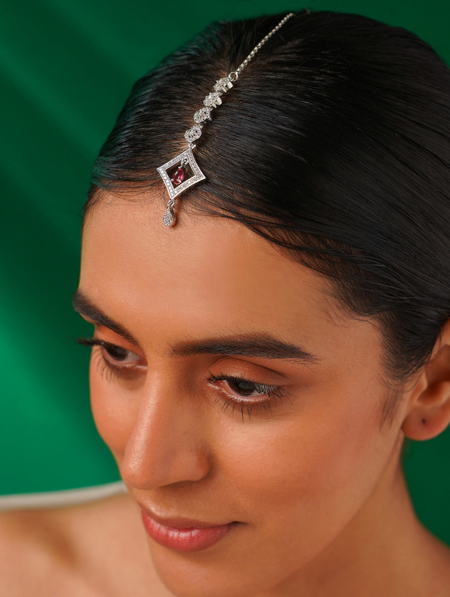 Silver Plated American Diamond Maangtikka worn on forehead with intricate design and red center stone