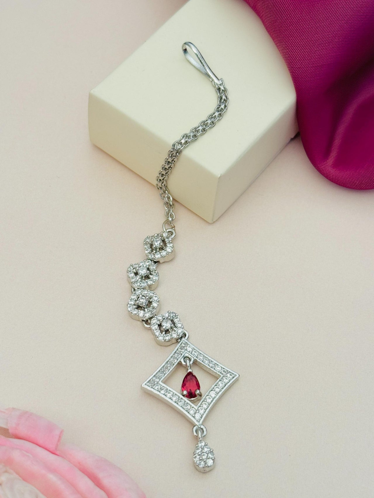 Silver Plated American Diamond Maangtikka with intricate floral design and red stone pendant