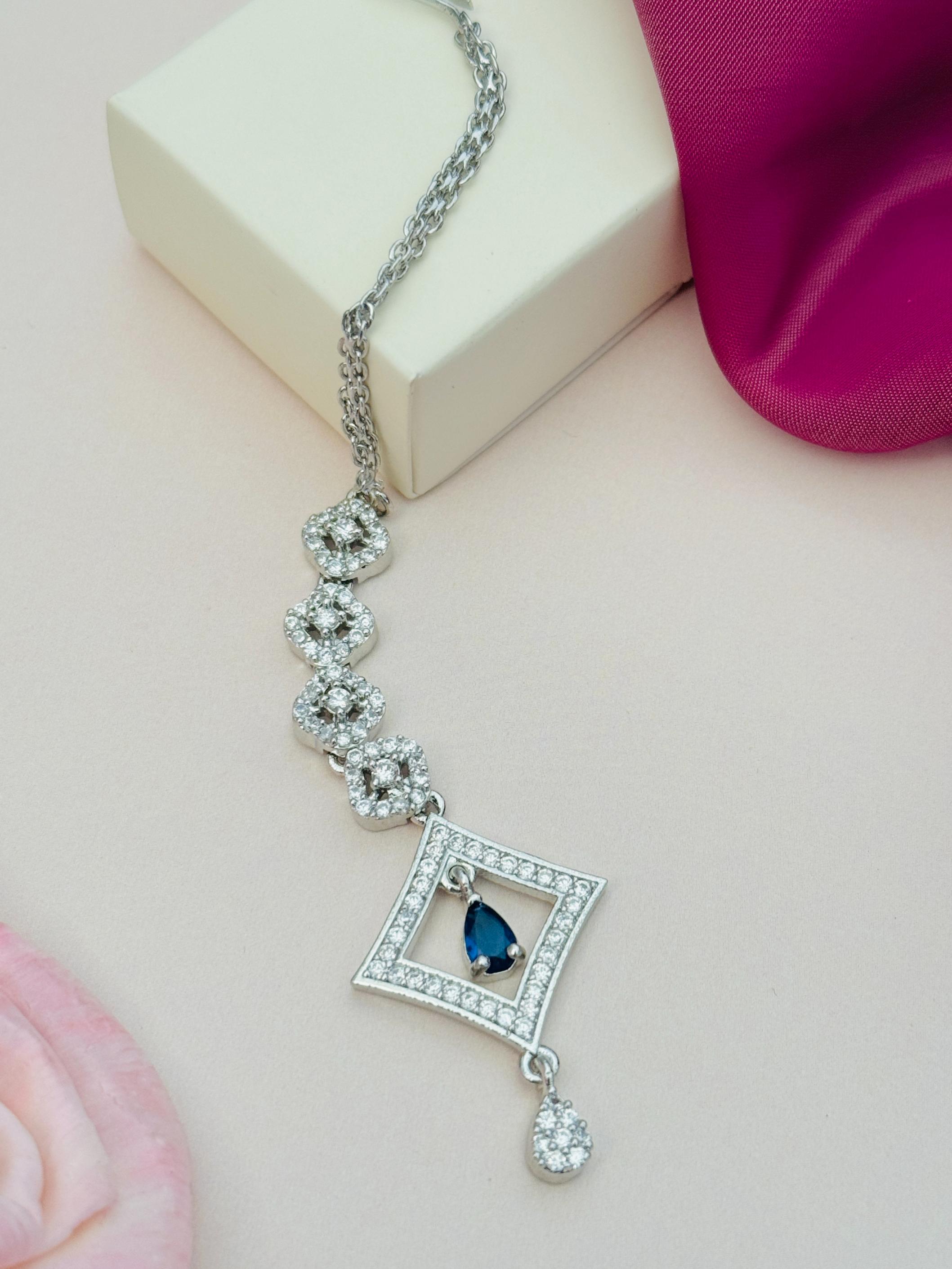 Silver Plated American Diamond Maangtikka with blue stone pendant and intricate chain design by Abdesignsjewellery