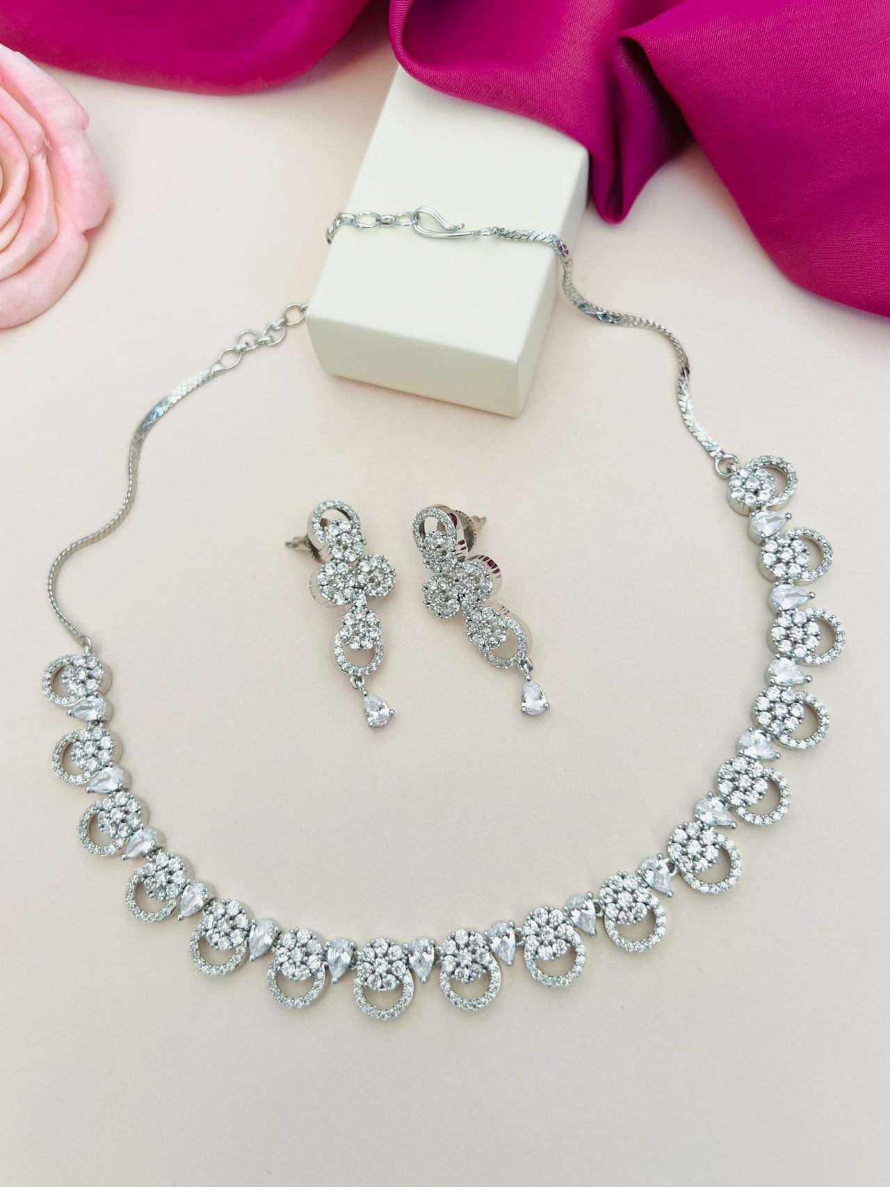 Silver Plated American Diamond Necklace with matching earrings from Abdesignsjewellery on soft background