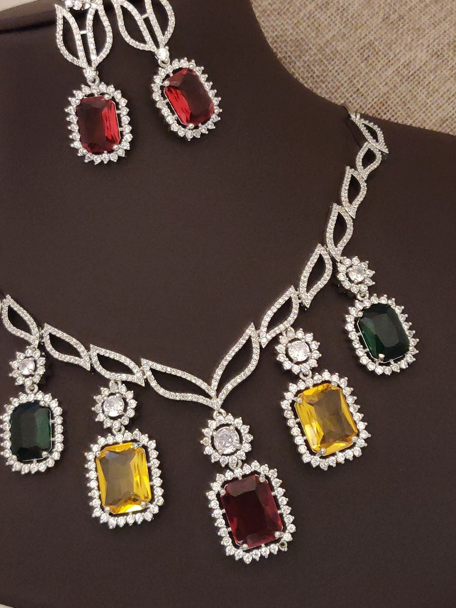 Silver plated American diamond necklace set with colorful jewel accents and matching earrings