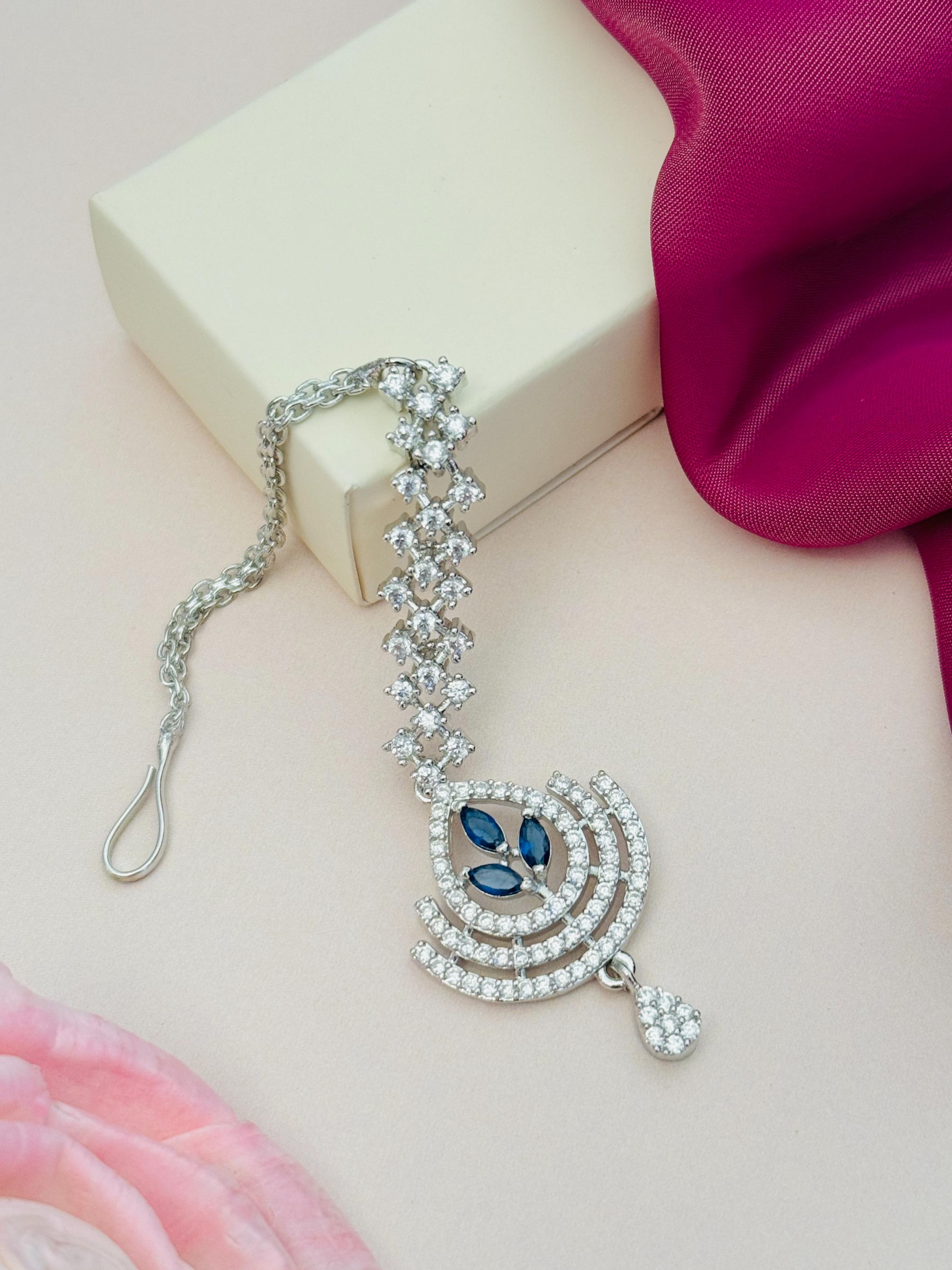 Silver Plated American Diamond Wedding Maangtikka with blue stones and intricate floral design by Abdesignsjewellery