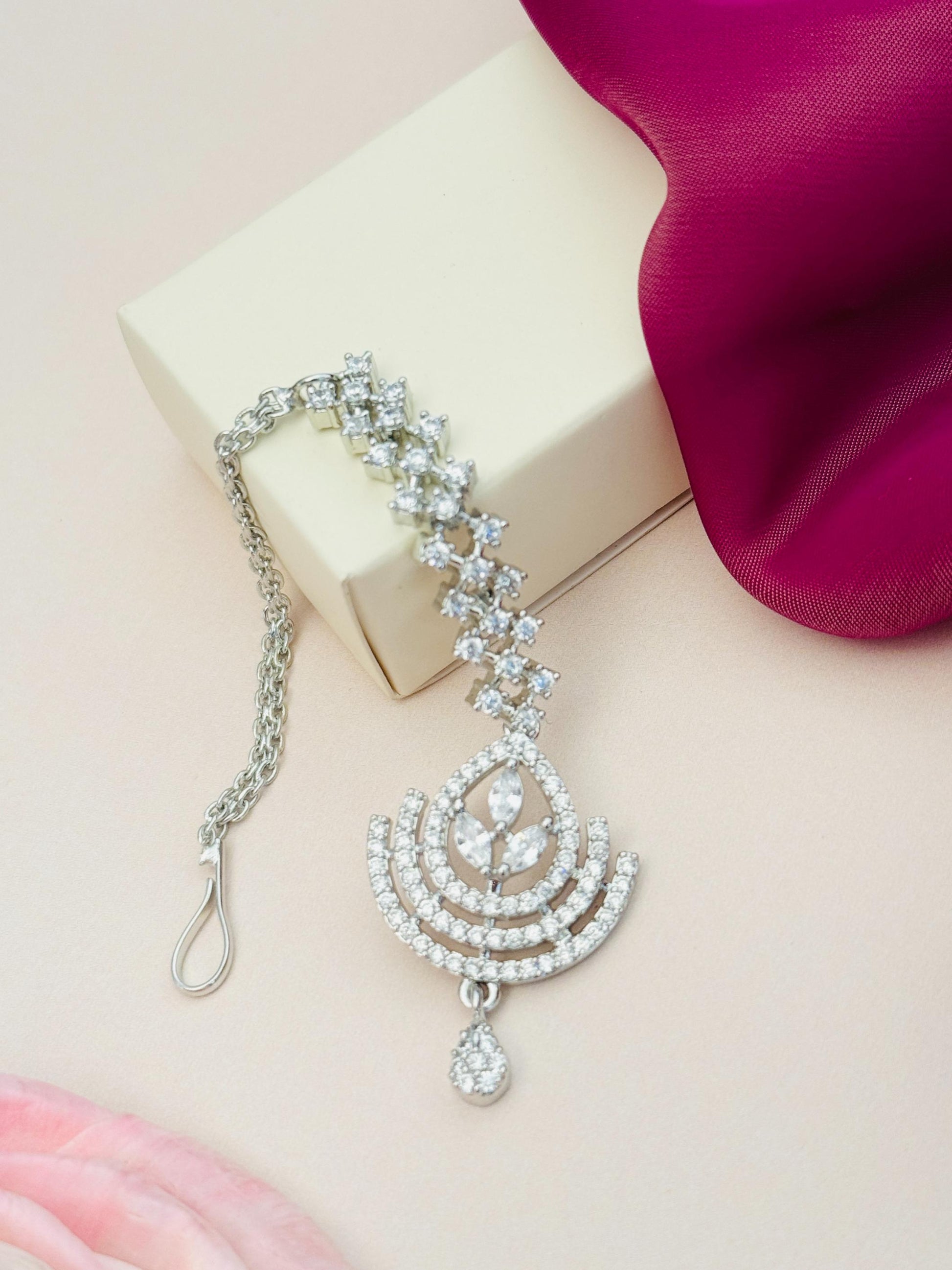 Silver Plated American Diamond Wedding Maangtikka with intricate design by Abdesignsjewellery displayed on a box