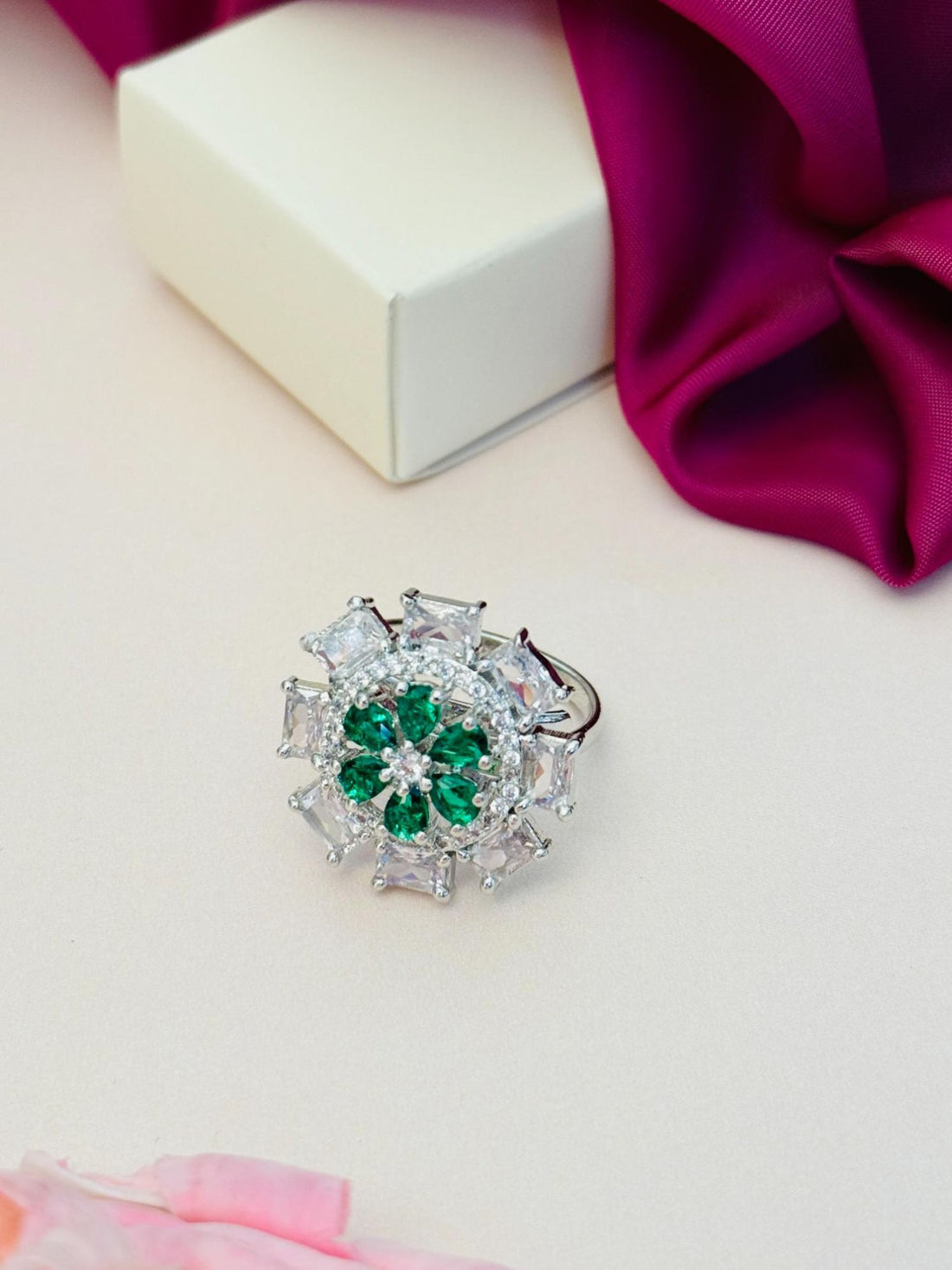 Silver Plated Elegant Design Ring featuring green and clear gemstones worn on finger