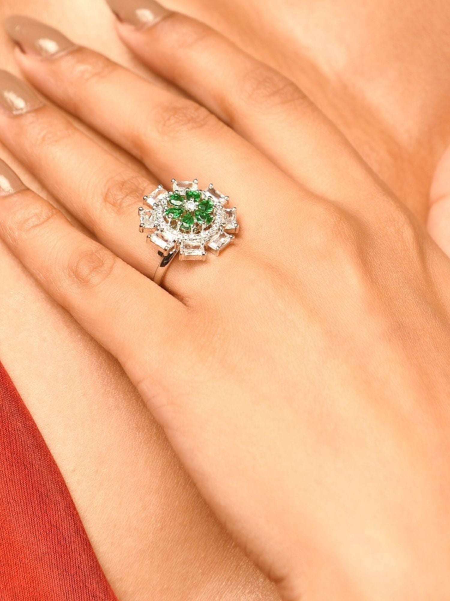 Silver Plated Elegant Design Ring featuring green and clear gemstones worn on finger