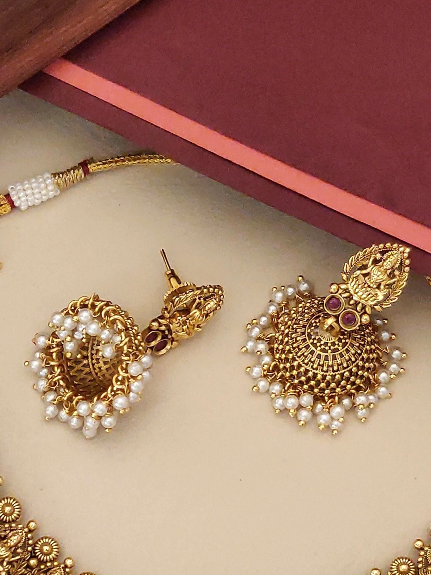 South Indian antique temple necklace with intricate designs and pearl detailing for traditional elegance