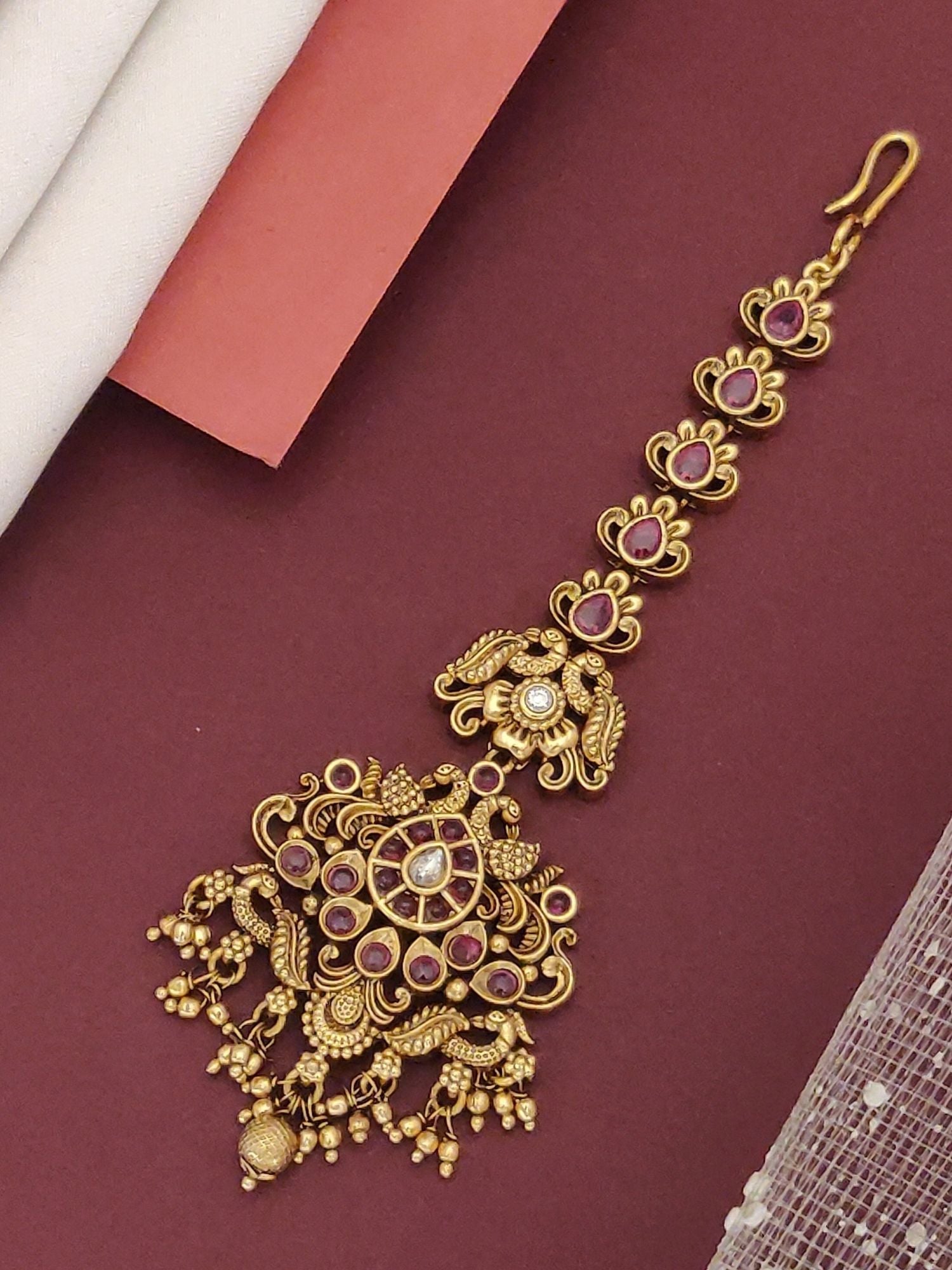 South Indian Style Gold Plated Maangtikka featuring intricate designs and vibrant gemstones