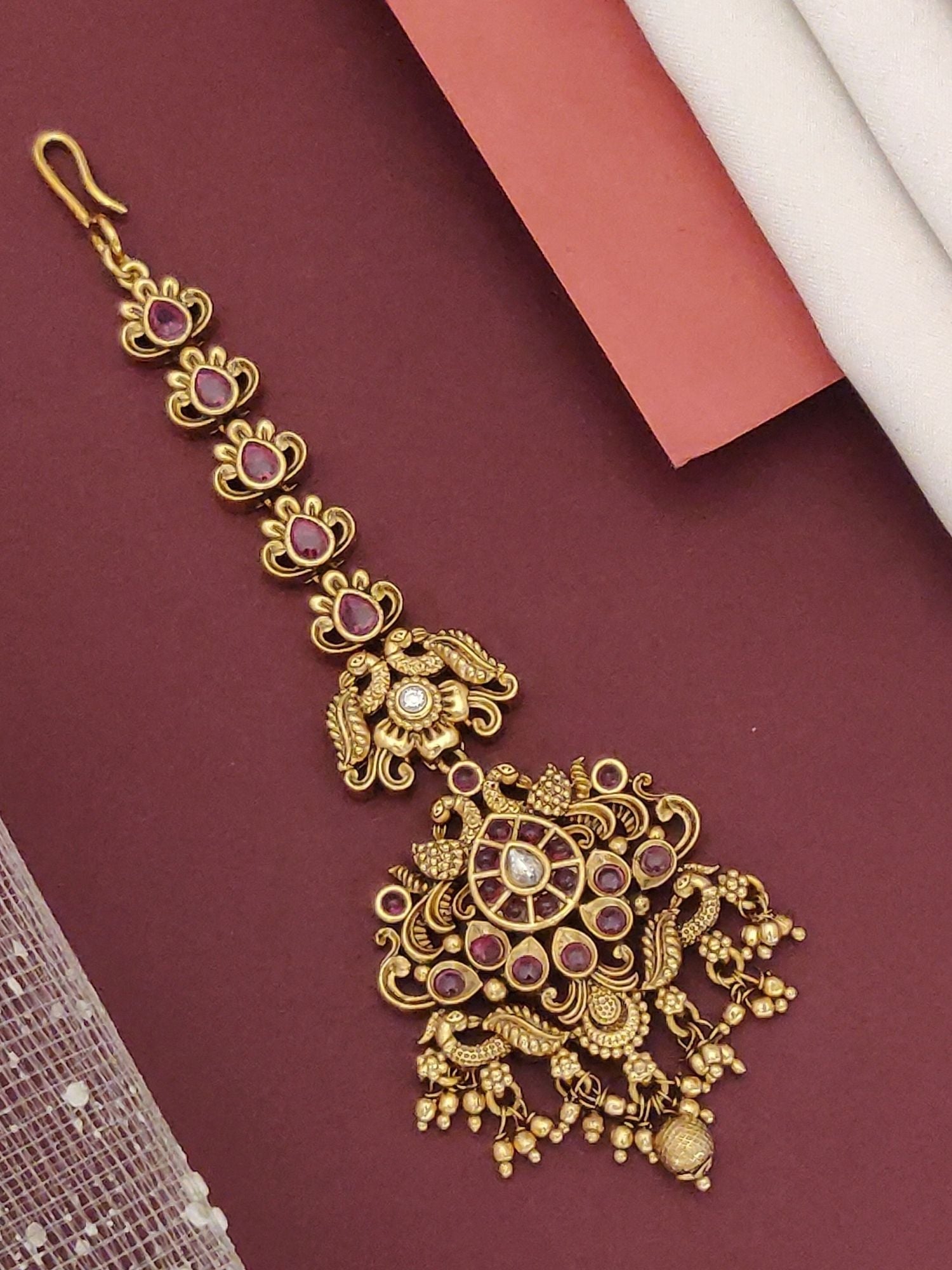 South Indian Style Gold Plated Maangtikka with intricate design and colorful embellishments for traditional occasions