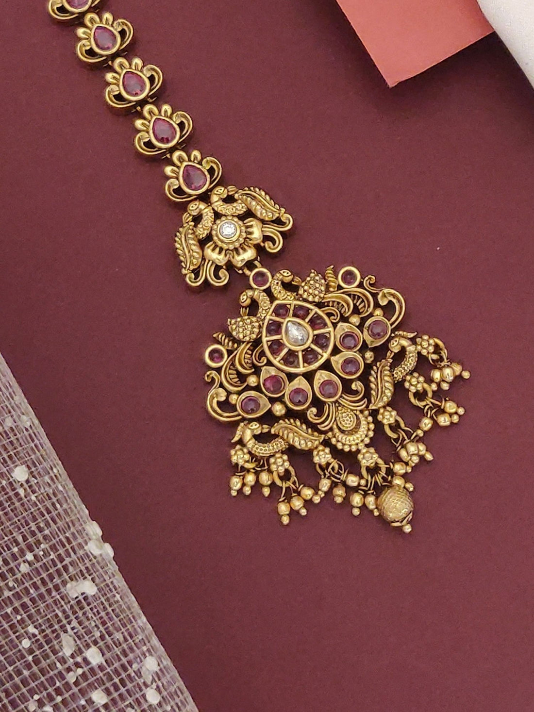 South Indian Style Gold Plated Maangtikka with intricate design and colorful embellishments for traditional occasions