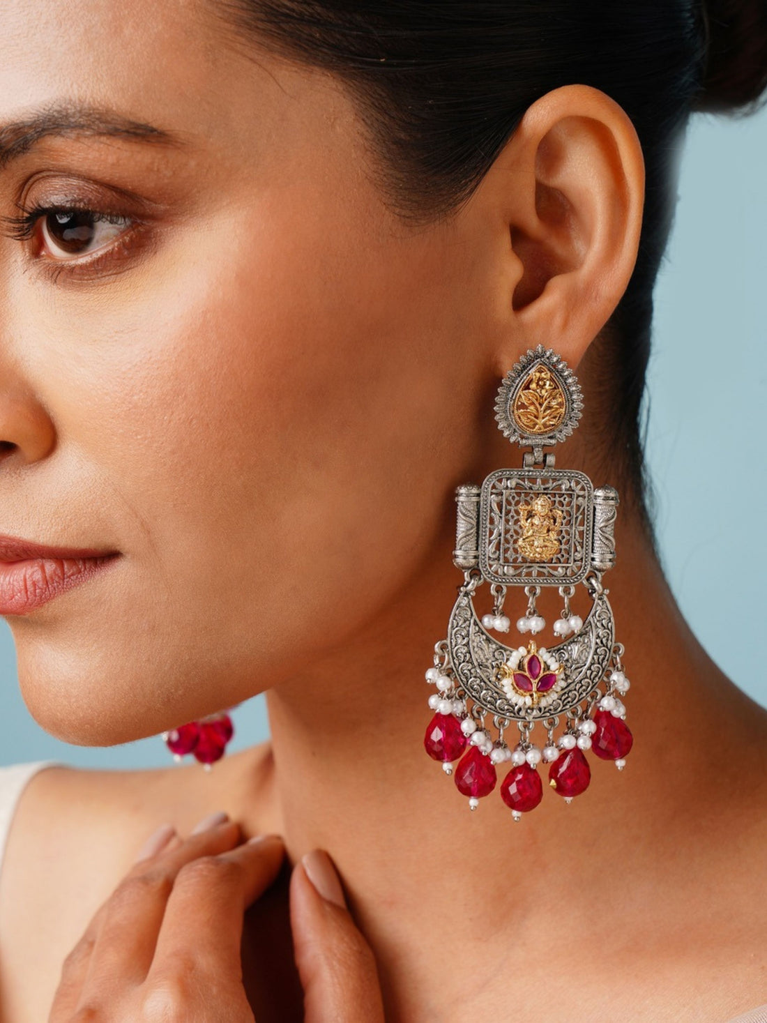 Temple South Indian German Silver Chandbali Earrings by Abdesignsjewellery worn on woman with intricate design and red bead details