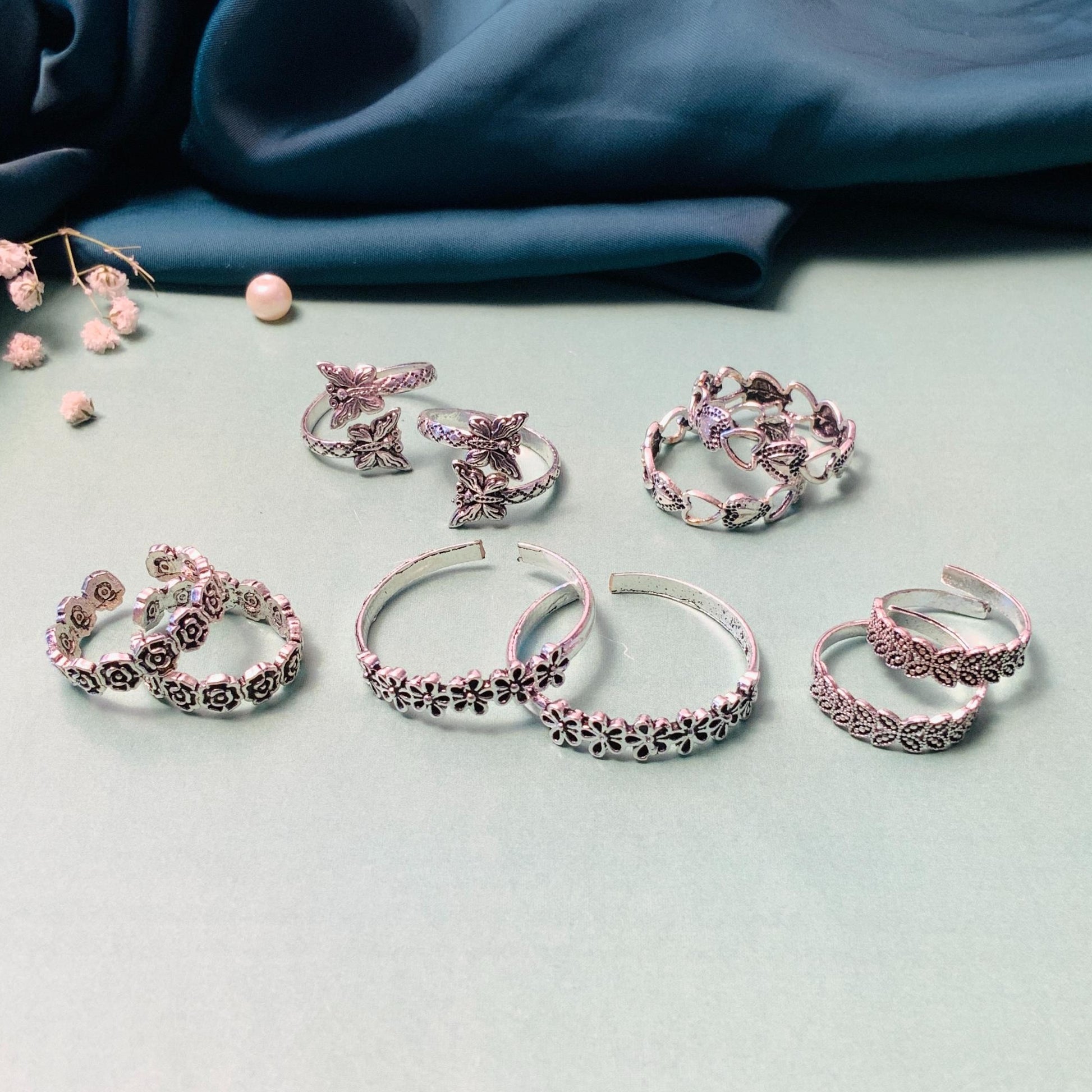 Collection of stylish toe rings featuring floral and butterfly designs by Abdesignsjewellery