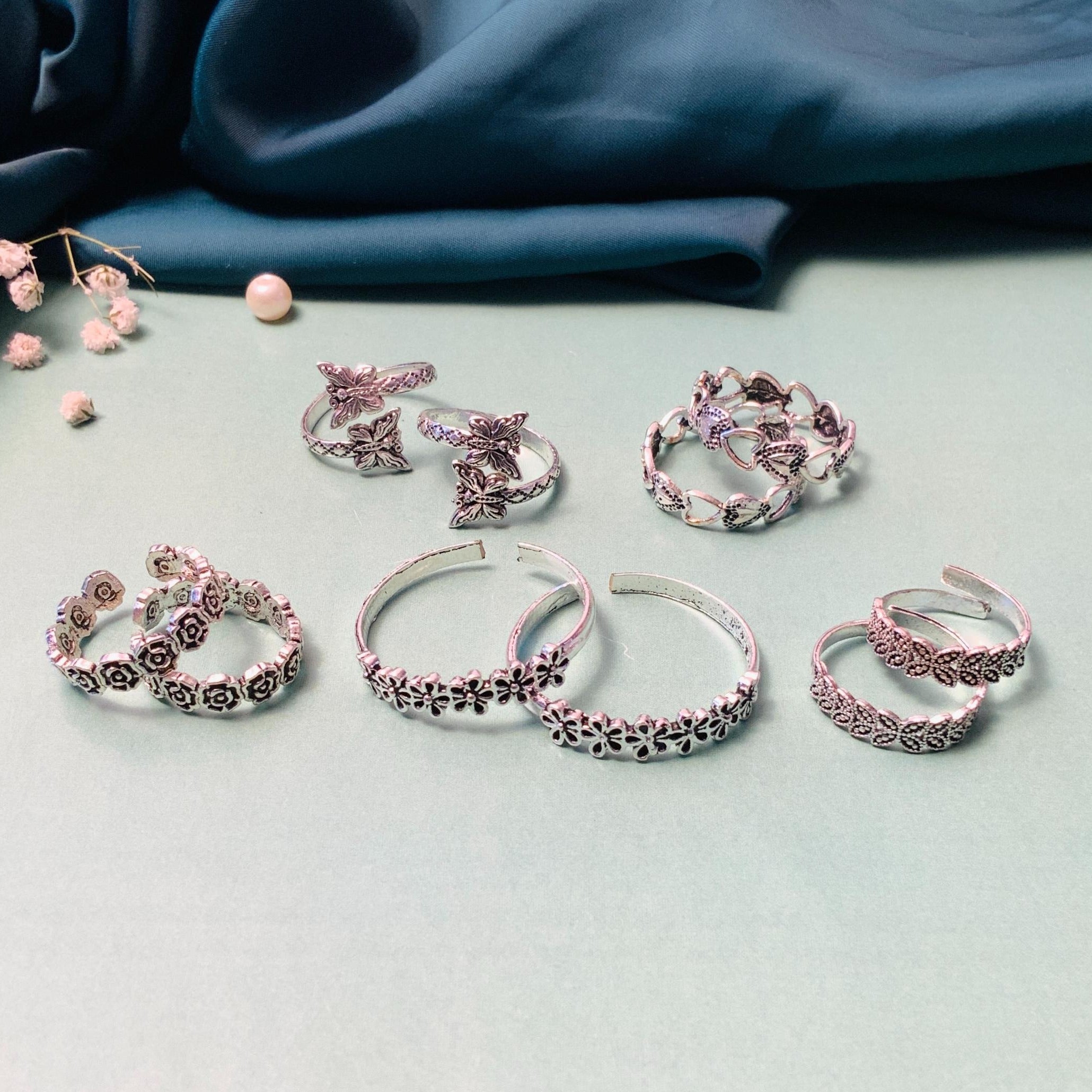 Collection of stylish toe rings featuring floral and butterfly designs by Abdesignsjewellery