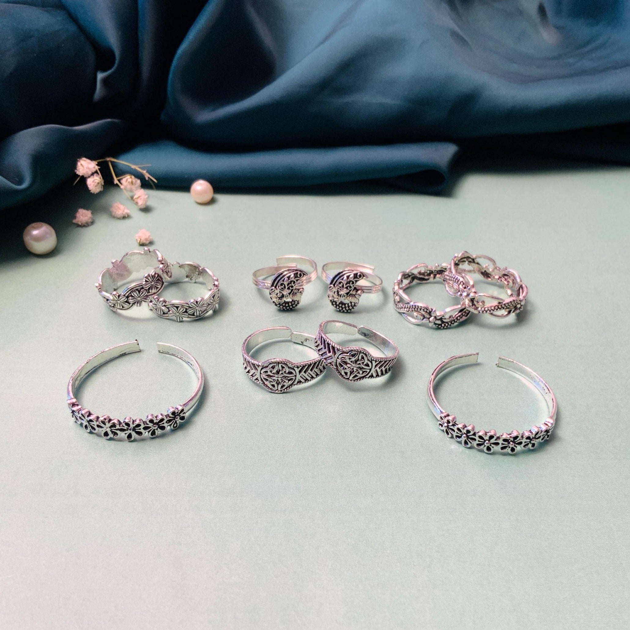 Set of elegant silver toe rings by Abdesignsjewellery featuring intricate designs and floral motifs