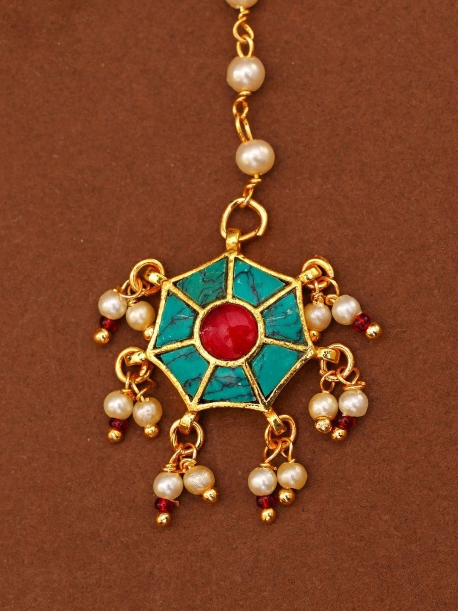 Traditional gold maangtikka with turquoise and red stone detailing and pearl accents by Abdesignsjewellery