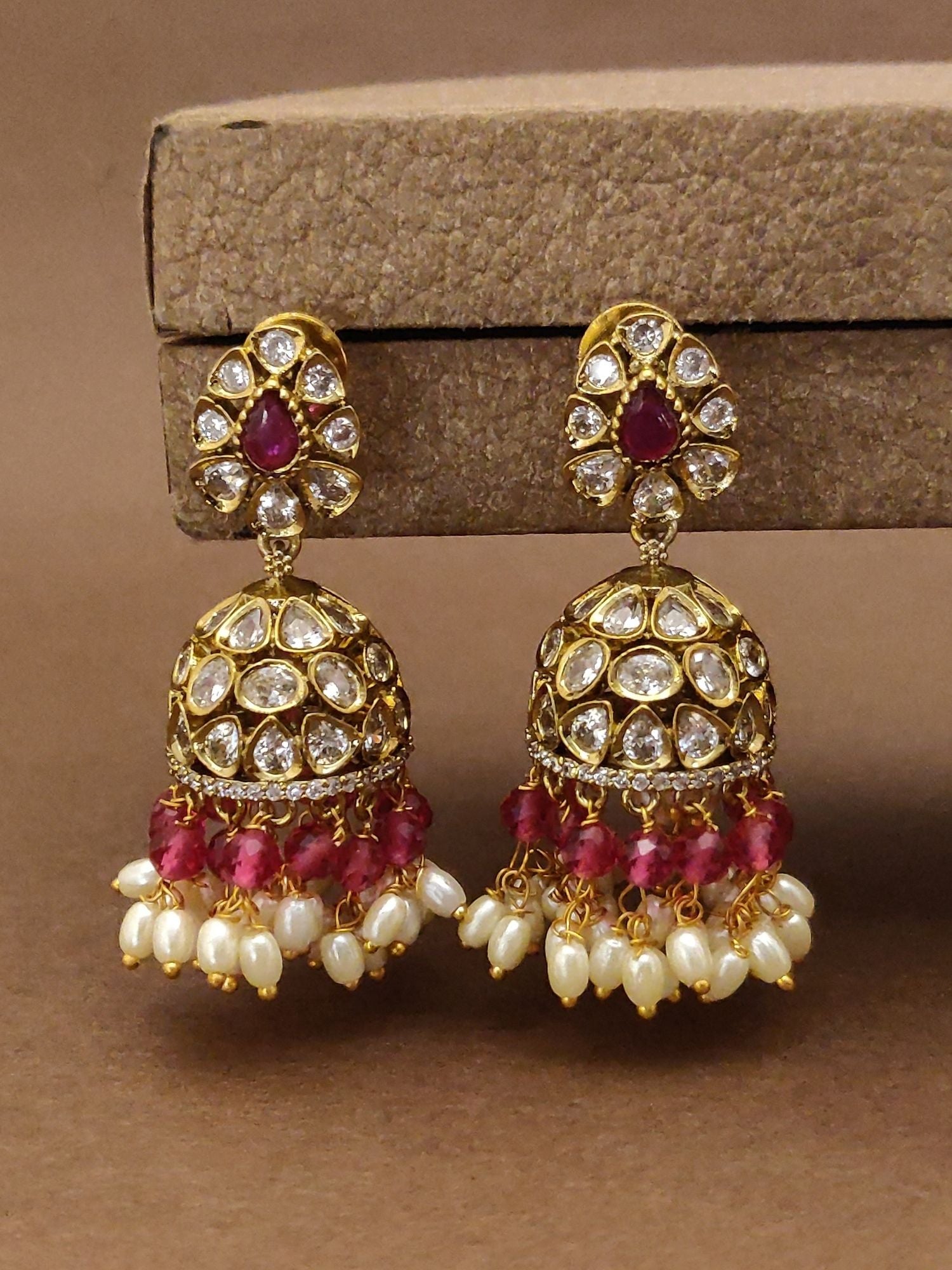 Traditional South Indian wedding earrings with gold, white stones, and red bead detailing by Abdesignsjewellery