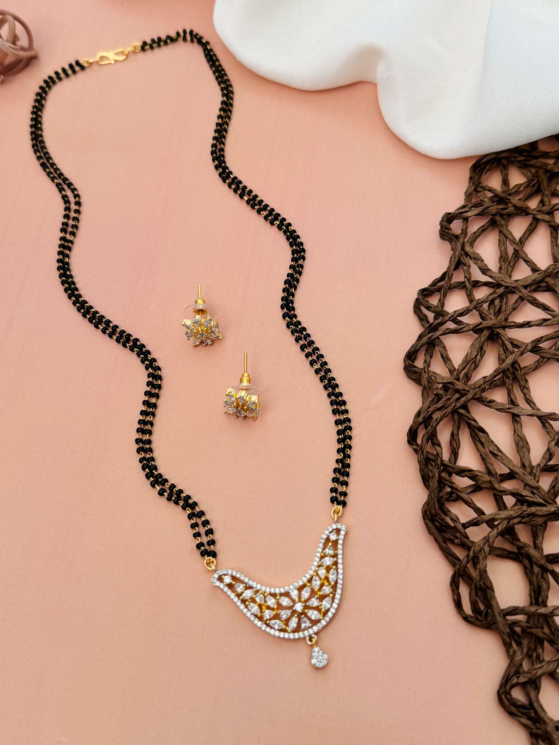 Unique American Diamond Mangalsutra Set with intricate gold pendant and matching earrings by Abdesignsjewellery
