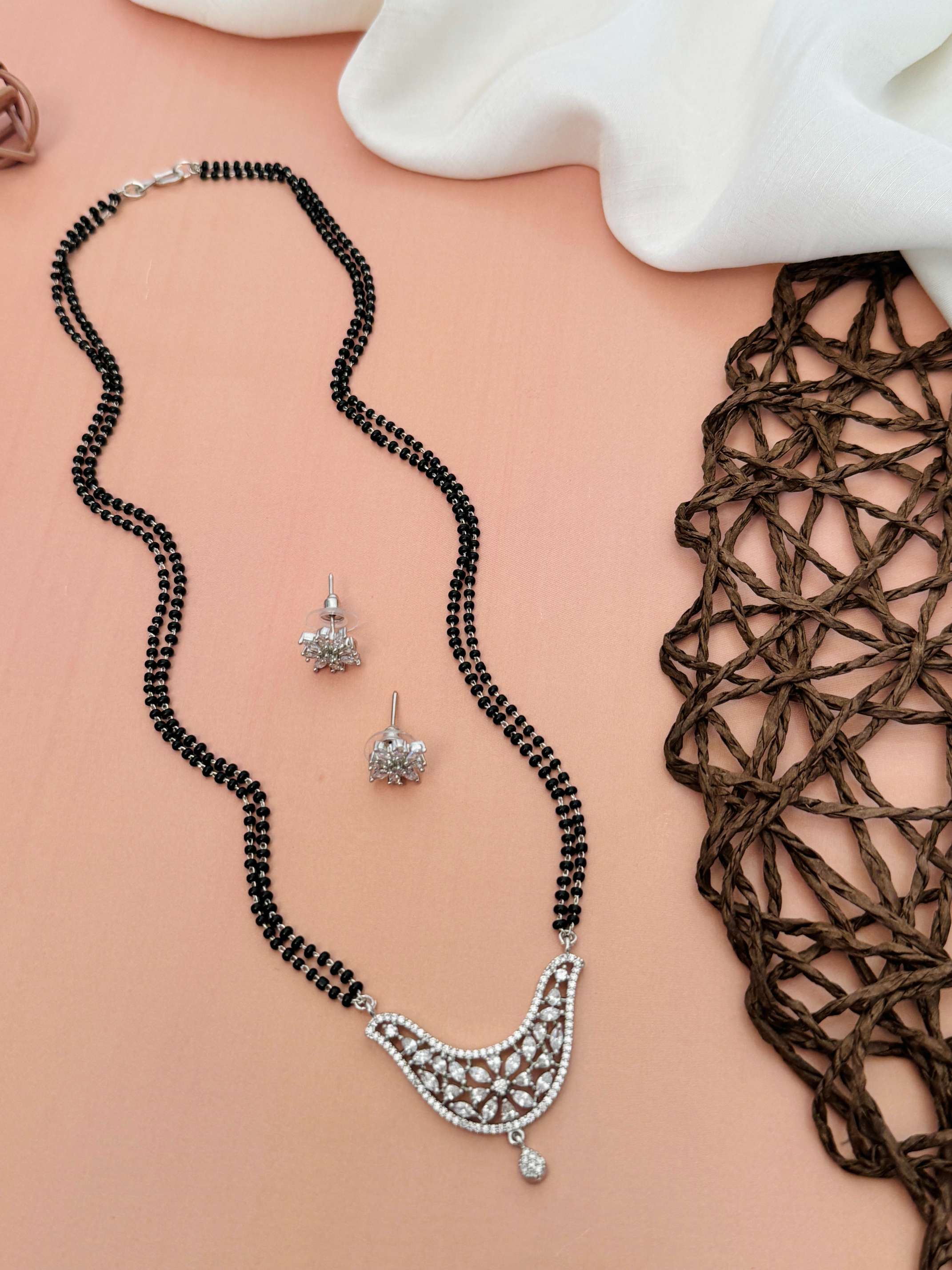 Unique American Diamond Mangalsutra Set with black beads and intricate silver pendant with matching earrings