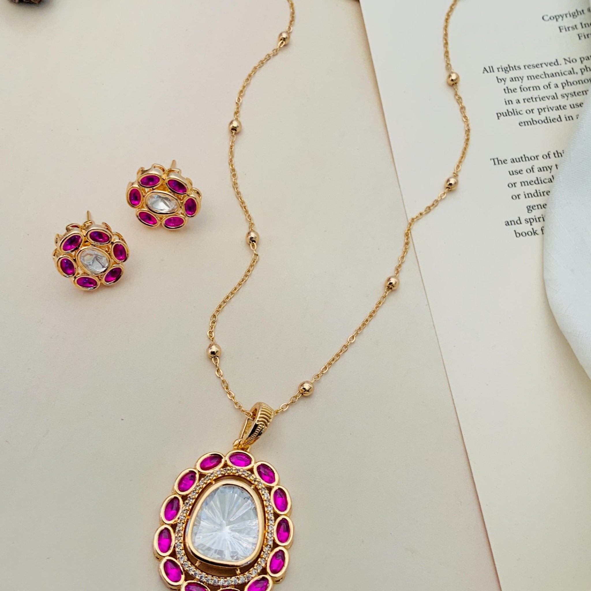 Gold Plated Navratna Pendant Chain Combo with pink gemstone accents and matching earrings by Abdesignsjewellery