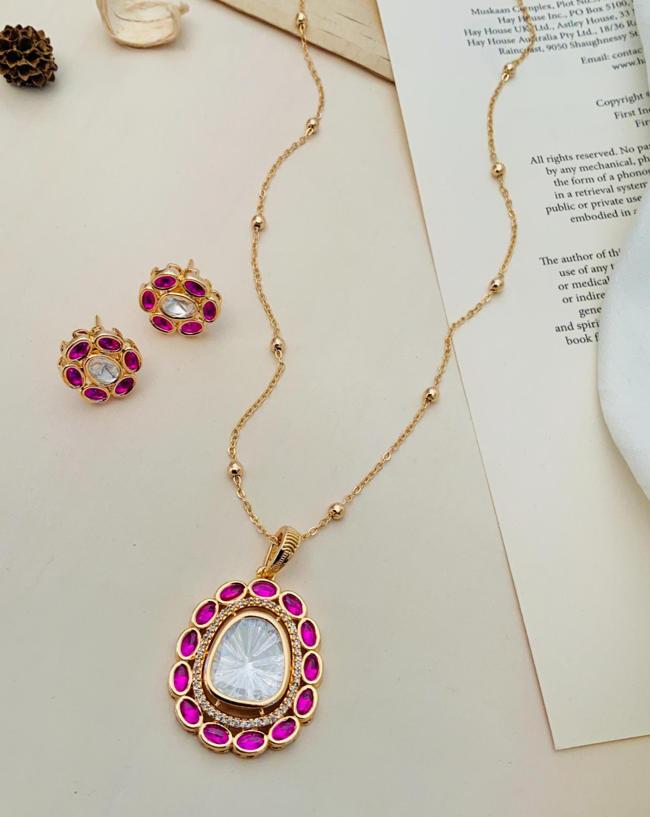 Gold Plated Navratna Pendant Chain Combo with pink gemstone accents and matching earrings by Abdesignsjewellery