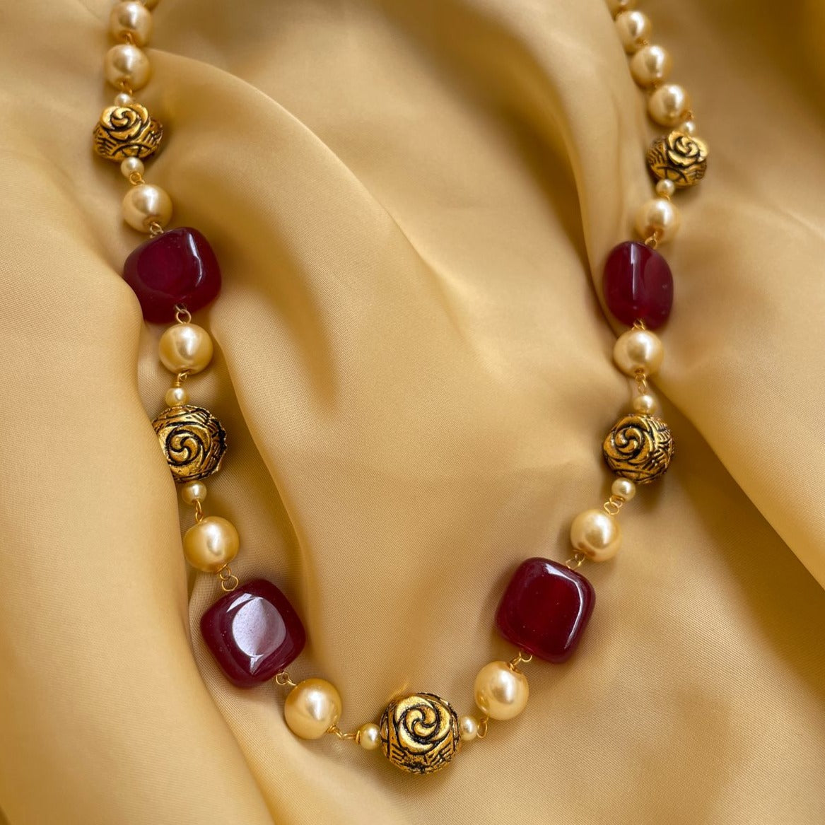 Elegant Mala Necklace by Abdesignsjewellery featuring red gemstones and gold decorative beads
